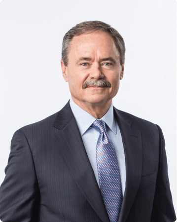 Gene E. Mergelmeyer, Assurant's COO dressed in a suit and tie looking at the camera