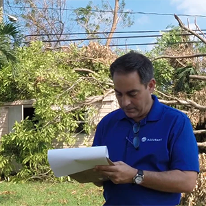 Man in the field writing down notes on a notepad