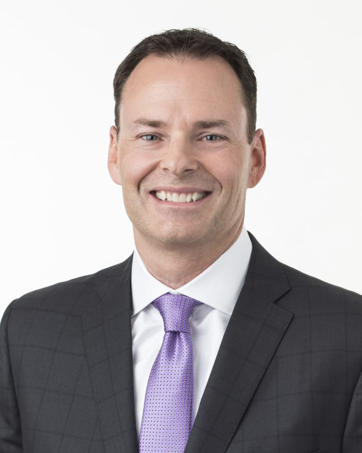 Keith Meier, Assurant's President International dressed in a suit and tie looking at the camera